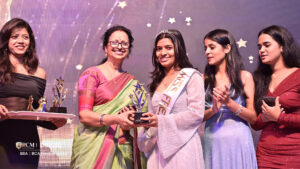 A student receiving the Miss award at a college festival.