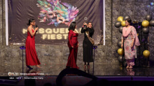 A girl winning a miss fresher trophy.