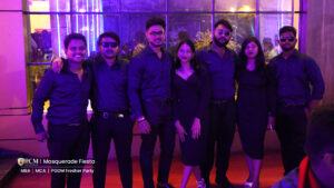 A group of individuals wearing black shirts stands together, smiling for a photograph.