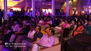 Chief guests sitting on the sofa and watching college freshers program