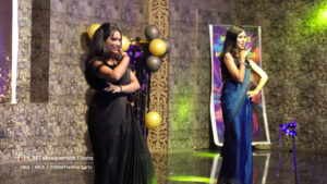 Two girls wearing saree dancing in a college freshers party