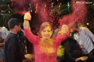 Beautiful girl joyfully enjoying Holi with vibrant colors