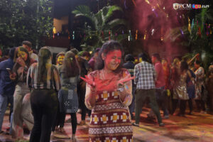 Students joyfully celebrating Holi with vibrant colors at RCM