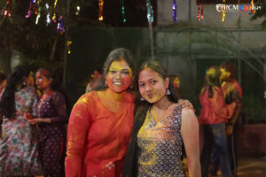 RCM students splashing colors in the air during Holi celebrations.