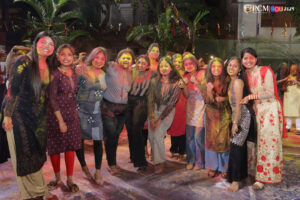 Friends posing with colorful faces during Holi celebrations at RCM.