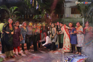 Excited students celebrating Holi with water balloons and colors.