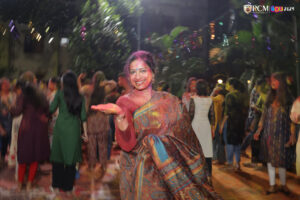 Professors and students embracing the joy of Holi with festive colors.