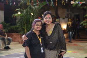 Students and staff joyfully celebrating Holi with vibrant colors.