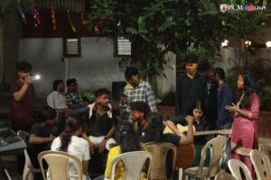 campus buzzing with live music and dance during Holi celebrations.