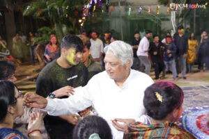 Professors engaging in Holi fun with students in a vibrant atmosphere