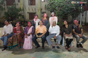 Professors and staff enjoying Holi festivities with students at RCM.