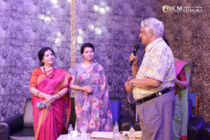 Guest engaging in conversation with the chairman during Lumora event