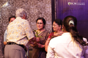 Guest with the chairman following their award presentation at Lumora