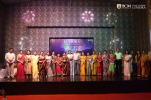 Group of guests smiling for a photo at Lumora event