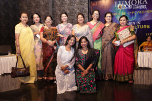 Guests posing for a group picture at Lumora event