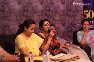 Woman musician playing an instrument during Lumora event