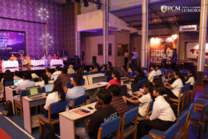 Attendees gathered around artwork created by women artists at Lumora
