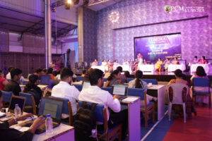 Visual artist explaining her exhibit at Lumora