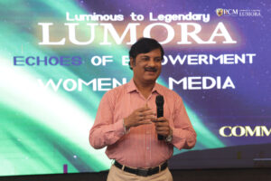 Manoj Kumar Satapathy delivering a speech at the Lumora event at RCM, highlighting the importance of women in media.