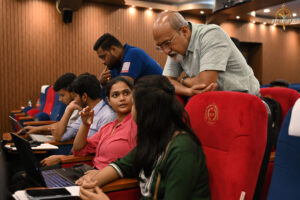 Judge reviewing participants’ financial strategies during the BID TO WIN stock market simulation at RCM.