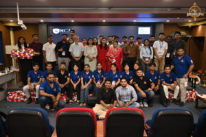 Bid to Win judges with participating team during the Brahmastra 2025 stock market simulation event at RCM.