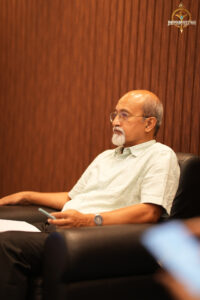 Judge evaluating participants during the intense BID TO WIN stock trading simulation at RCM’s Brahmastra 2025 event.