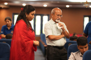 judge observing participants during the high-stakes BID TO WIN stock market simulation event at RCM.