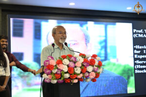 Judge delivering a powerful speech during the "Bid to Win" event at RCM, inspiring participants in the financial trading simulation.