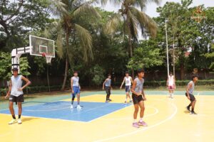 College students competing in an intense basketball match during Brahmastra 2025 at RCM Bhubaneswar