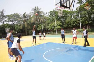 Students playing intense basketball match during Brahmastra 2025 event at Regional College of Management (RCM), Bhubaneswar