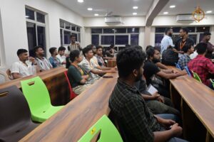 Students inside the hall at Brahmastra college festival participating in HackForge AI hackathon at top management college.