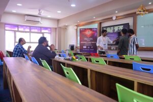 Students explain their AI project to judges on stage during Brahmastra—India’s top college festival hackathon.