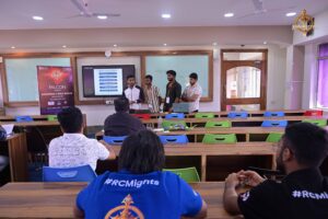Student presenting AI project during HackForge at Brahmastra, top college festival in India at leading management college.