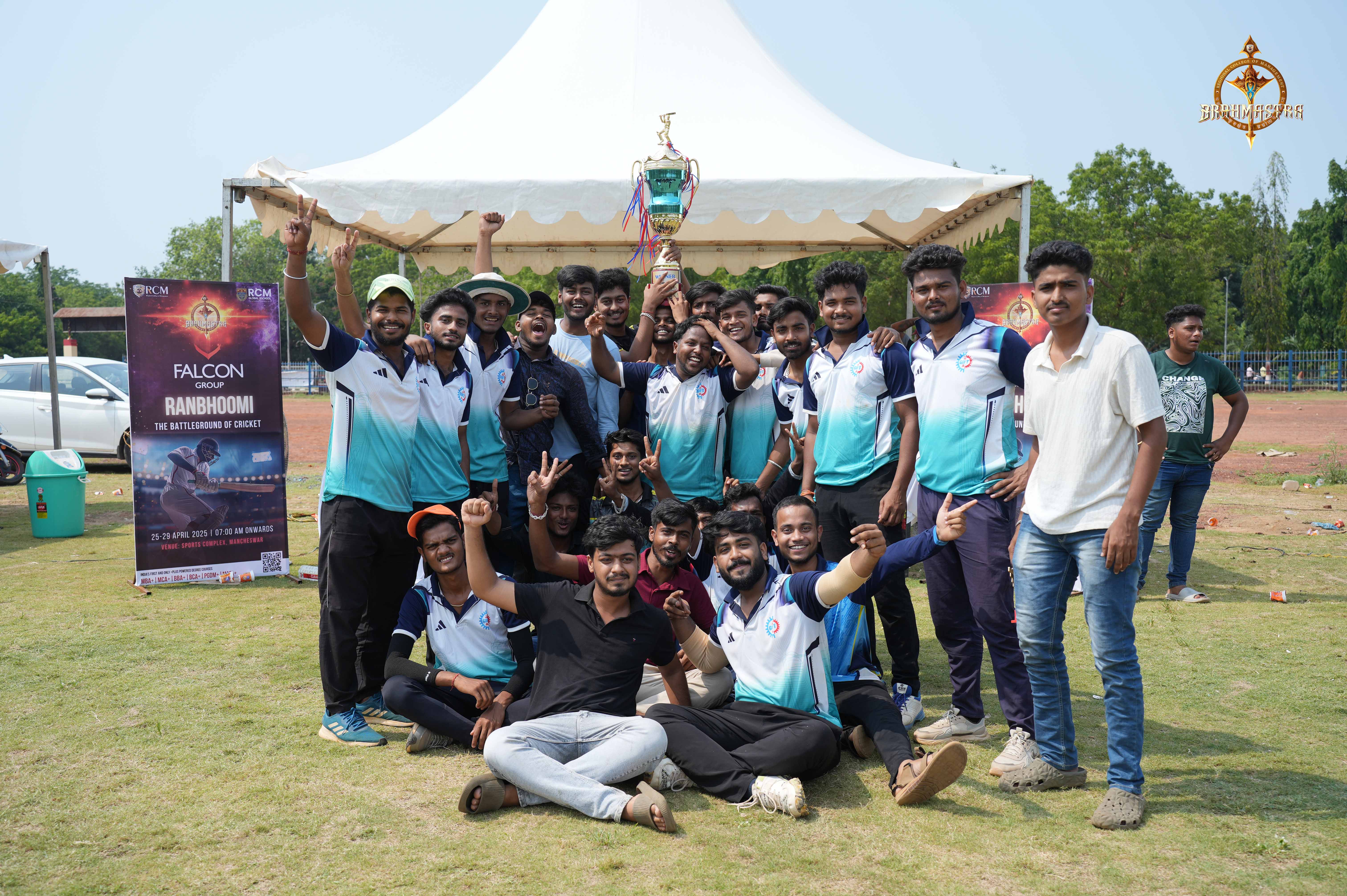 Winning team from Autonomous College celebrating Ranbhoomi cricket victory with trophy at Brahmastra 2025