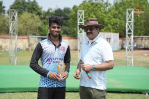 Student receiving cricket award from faculty during Brahmastra 2025 Ranbhoomi event