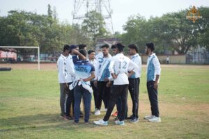 Intercollege Ranbhoomi cricket players in jerseys chatting on the pitch at Brahmastra 2025