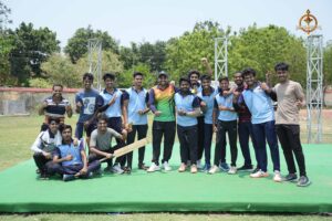 Group of college cricket players posing together during Ranbhoomi at Brahmastra 2025, wearing team jerseys on the field.