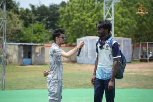 Event official in conversation with a cricket player during Ranbhoomi at Brahmastra 2025.