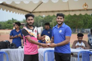 Captain presenting the trophy to a standout cricket player at the Ranbhoomi event during Brahmastra 2025.
