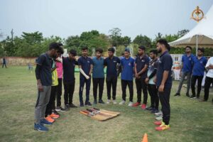 Group photo of intercollege cricket teams at Ranbhoomi during Brahmastra 2025, standing together on the field in team jerseys.