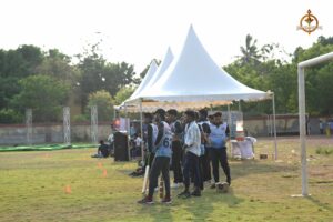 Cricket team watching the match intently from the sidelines during Ranbhoomi at Brahmastra 2025.
