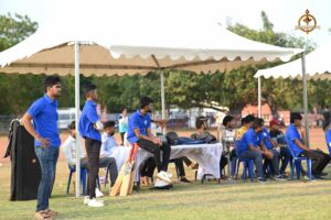 cricket team attentively watching a live match at Brahmastra 2025.