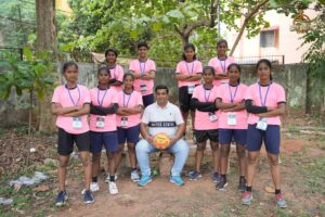 Girls throwball team posing with coach on field during Brahmastra 2025 Kurukshetra