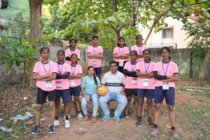 "Group photo of girls’ throwball team with coach at Brahmastra 2025 Kurukshetra event.