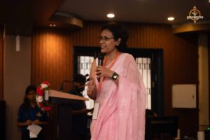 Guest speaker addressing the audience at Navya Sopna 2025, sharing insights on entrepreneurship.