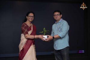 Guest receiving a plant sapling during the Navya Sopna entrepreneurship event at RCM.