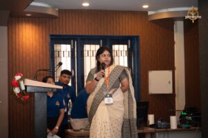 A young startup entrepreneur confidently presenting her idea on stage during Navya Sopna at Brahmastra 2025.