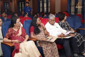 Judges and faculty evaluating entrepreneurial pitches on stage during Navya Sopna at RCM.
