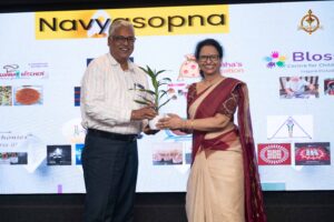 Judges receiving plants as tokens of appreciation during the Navya Sopna event at Brahmastra 2025 college festival.