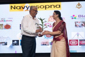 Judges receiving plant tokens during Navya Sopna at Brahmastra 2025, a college festival promoting entrepreneurship.